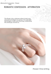 Detail of vine design ring featuring light blue gemstones and silver leaf texture