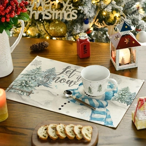 Close-up of Let it Snow Christmas placemat with snowman and pine tree pattern