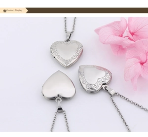 Detailed view of three polished heart locket necklaces with vintage vine engravings