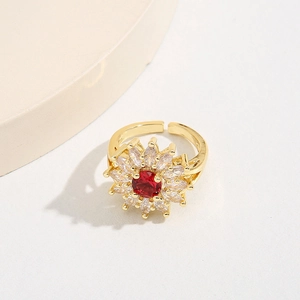 Exaggerated sunflower open ring with red center stone and clear zircon petals in gold finish