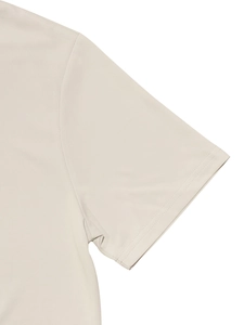 Detailed close-up of double-needle stitching on beige men's sportswear set shoulder seam
