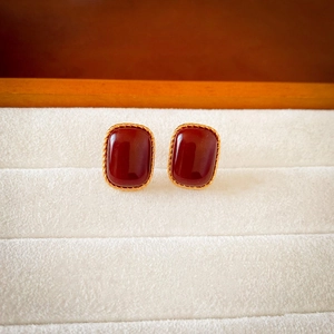 Macro detail of vintage rectangular resin earrings with gold twisted rope metal edges