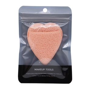 Pink heart-shaped facial sponge in transparent self-sealing packaging with hanging hole