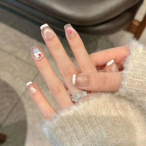 Cat eye press-on nails with French tips, 3D bow and cake charms on hand with ring