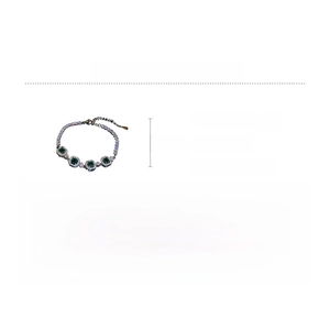 Detailed view of emerald geometric bracelet with zircon settings and copper base dimensions