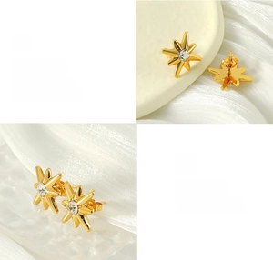 Detailed macro view of gold plated starburst stud earrings with centered zircon stone