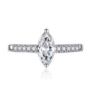 Macro shot of marquise-cut crystal ring with side diamonds and reflective surface