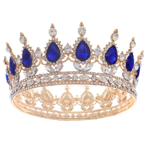 Luxury gold bridal crown featuring blue teardrop gems and sparkling rhinestones