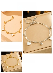 Close-up of heart pendant bracelet with S.STEEL hallmark tag and lobster clasp