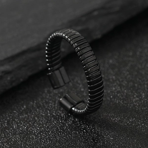 Minimalist black stainless steel C-shaped ring with horizontal textured wave design