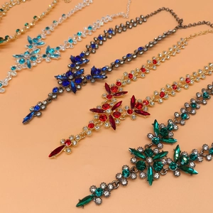 Detailed view of multi-color crystal bridal necklaces in blue, red, green and clear stones