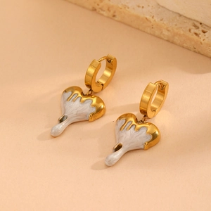 Modern gold heart earrings with white enamel melting drip design on textured stone base