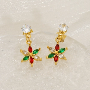 Macro shot of gold vintage flower earrings with red, green, and clear zircon gemstones