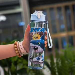 Gros plan sur gobelet bleu clair avec paille, motif requin et sangle de transport