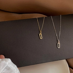 Macro detail of gold and silver oval pendants with sparkling pavé crystals on a chain