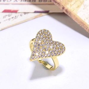 Detailed close-up of a gold-plated heart ring with shimmering pavé zircon stones