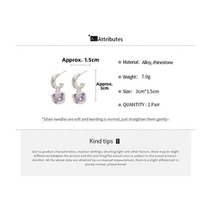 Detail view of silver earrings featuring purple cat-shaped rhinestones with size dimensions