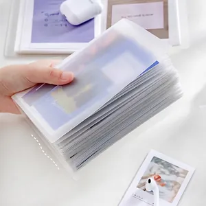 Frosted translucent PP photo album for Polaroid prints shown in a lifestyle desktop setting