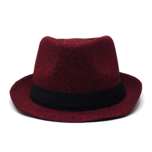 Close-up of dark red wool fedora hat with black ribbon detail and textured finish