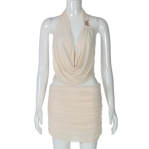 Detail of beige halter drape top with metal neckline and matching ruched mini skirt