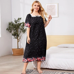 Plus size black nightgown with floral print, lace neckline, and starry patterns