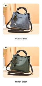 Detail view of stylish hand bags in blue-grey and dark green with detachable straps