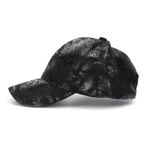Close-up of black baseball cap with dark floral jacquard and glossy satin texture
