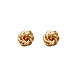Pair of gold metal swirl knot stud earrings with a polished finish on white background