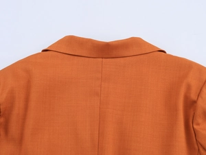Close-up of the back neckline and fine woven texture on this orange blazer for women