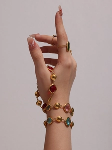 Close-up of 18k gold plated bracelet featuring vibrant Czech glass stones and matching rings