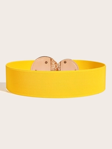 Detail of bright yellow wide elastic waist belt with a gold metal and beige leather buckle