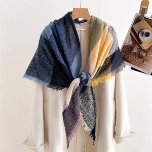 Plaid cashmere-like scarf with colorful fringe on a beige coat for autumn and winter