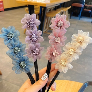 Handheld view of four-color floral hair bun makers with delicate mesh petals and beads