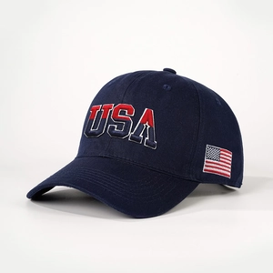 Detailed embroidery of the USA logo and American flag on a navy blue cotton baseball cap