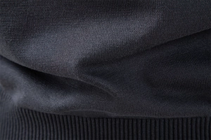 Macro shot of dark grey knit fabric with ribbing detail on men's long sleeve polo