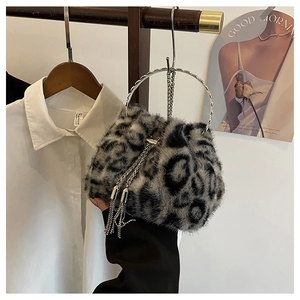 Detail of leopard print faux fur bucket bag with metal ring handle and tassel drawstring
