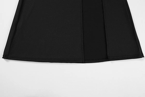 Detail of double-needle hem and side slit on black bodycon dress fabric texture