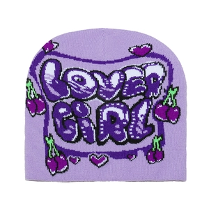 Detailed knit texture of purple beanie with LOVER GIRL text and cherry pattern