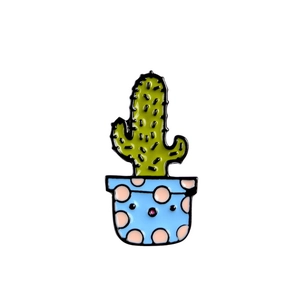 Cute cartoon cactus enamel pin badge with blue pot and pink dots on white background