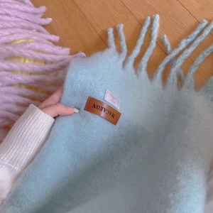 Soft macaron blue and pink cashmere-feel scarves with long fringes and leather label