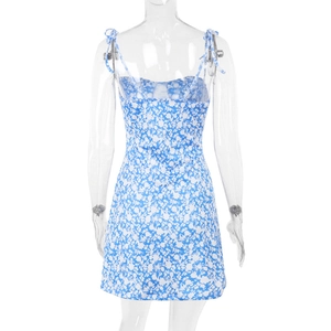 Detail of the back of a blue and white floral summer dress with thin strap tie design