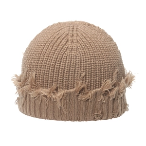 Detailed close-up of khaki knit beanie featuring vintage distressed fringe and ribbed texture