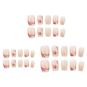 Press-on nails with golden autumn leaf design and nude base in a 30-piece manicure set