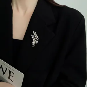 Elegant gold plated wheat brooch with pearls and zircon on black suit lapel