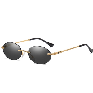 Rimless oval punk sunglasses with gold metal frame and gray lenses in a side view