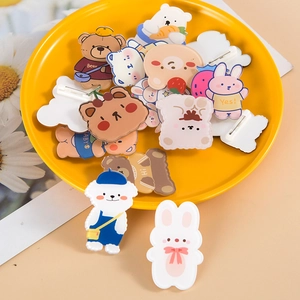 Cute acrylic cartoon bear and animal brooches set on a yellow round tray display