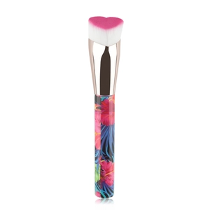 Detail of heart-shaped foundation brush with pink gradient bristles and floral handle