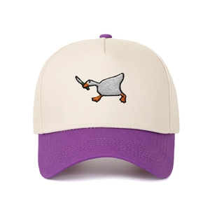 Close-up of the goose holding a knife embroidery on a beige and purple baseball cap