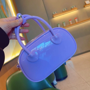 Detail of lavender purple PVC jelly handbag with glossy finish and heart-shaped handle joints