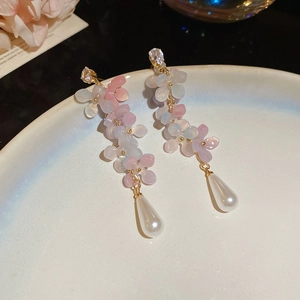 Close-up of floral tassel earrings with pink-blue gradient petals and teardrop pearls